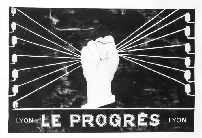 1933 - Une main d'homme sert un réseau de fils téléphoniques.